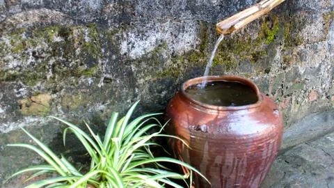 Water flows into the jar Stock Photos
