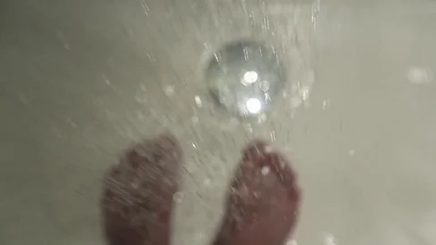 The water flows to the legs of a man Stock Footage 76479950