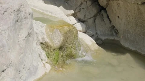 Water flows in mountain stream at sunny day 스톡 동영상 313893073