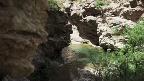 Water flows from the mountains into a small pond in Bar Montenegro Stock Footage 196126355