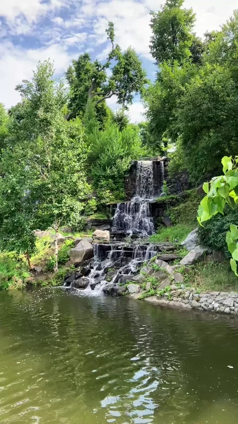 Water flows in multiple streams forming a stunning waterfall Stock Footage 314504771