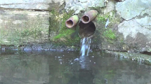Water flows from an old abandoned spring Stock Footage 36036572