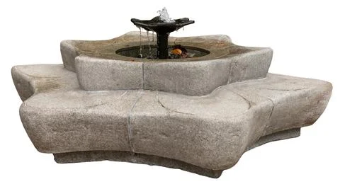 Water flows out from the center of a round stone fountain. The fountain has.. 写真素材