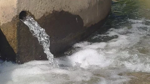 Water flows out of the concrete structure Stock Footage 155153828