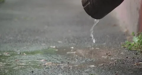 Water flows out of the downpipe during the rain Stock Footage 190961621