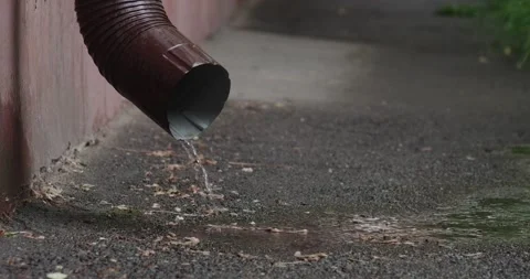 Water flows out of the downpipe during the rain Stock Footage 190962183