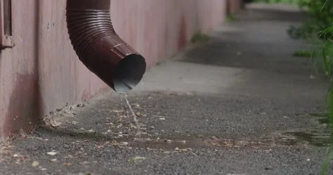 Water flows out of the downpipe during the rain Stock Footage 190962354