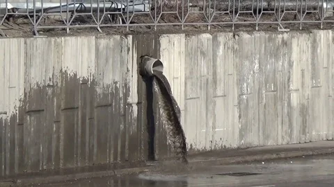 Water flows out of the drain pipe after rain Stock Footage 75563762
