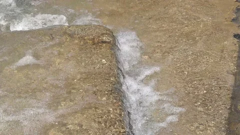 Water flows out over the stone Stock Footage 155153929