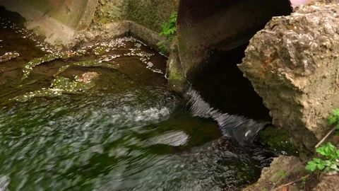 Water flows out of the pipe into the gutter. Stock Footage 153548705