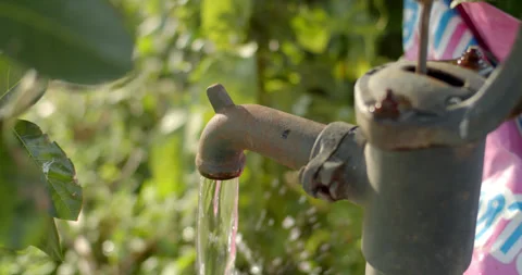 Water flows out of the well head.Pump water up from underground. Stock Footage 316591019