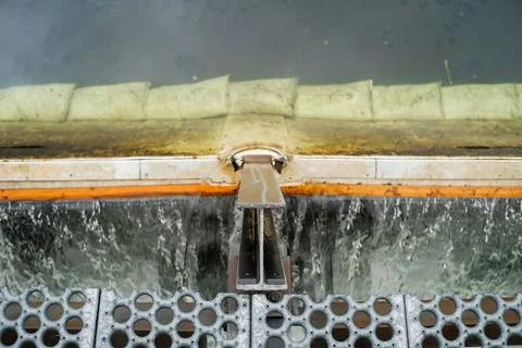 Water flows over an aeration structure in an artifical salmon spawning channel. Stock Photos
