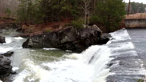 Water flows over a dam and into a river, 4K Stock Footage 158712436