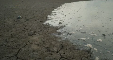 Water Flows over Dry Cracked Dirt, Flooding Water, Drought, 4K Stock Footage 239137426