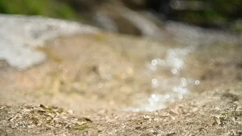Water flows over mountain rocks in summer (bokeh, slow motion) 스톡 동영상 219636405