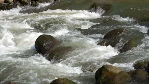 Water flows over river rocks Stock Footage 280684327