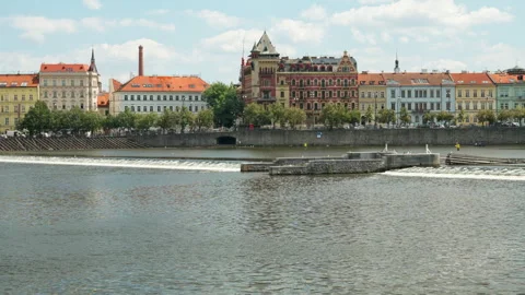 Water flows over a river weir on the Vltava River in historic Prague city 動画素材 342019225