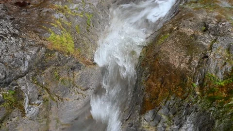 Water flows over rocks in a mountain stream Stock-Footage 211466438
