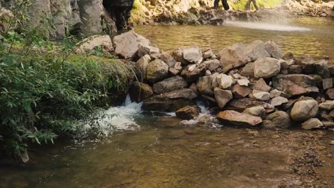 Water flows over rocks in a mountain river 動画素材 296273186