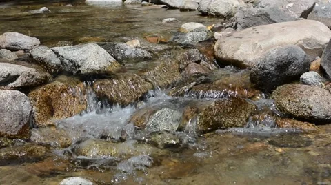 Water Flows Over Rocks in a Stream Stock Footage 54375402