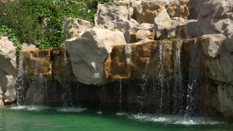Water flows over the stones into the pool Stock Footage 158157547