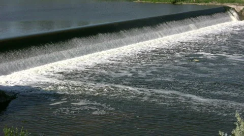 Water flows over a weir, creating small waterfall (High Definition) Stock Footage 365138