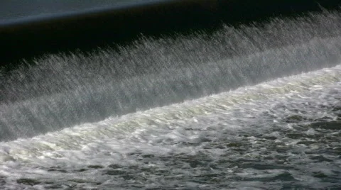 Water flows over a weir, creating small waterfall (High Definition) Stock Footage 365139