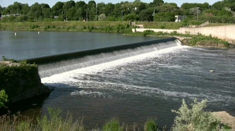 Water flows over a weir, creating small waterfall (High Definition) Stock Footage 365141