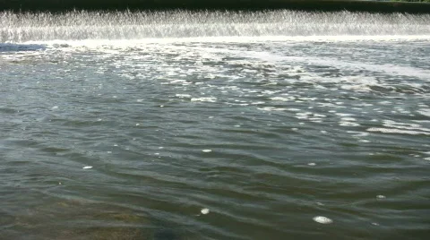 Water flows over a weir, creating small waterfall (High Definition) Stock-Footage 365142