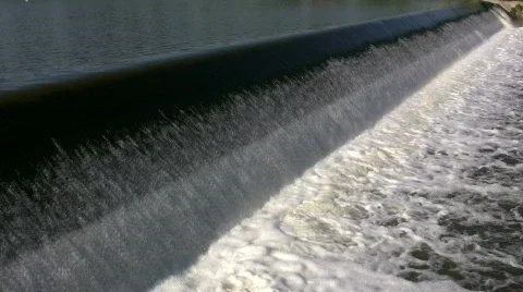 Water flows over a weir, creating small waterfall (High Definition) Stock-Footage 365145