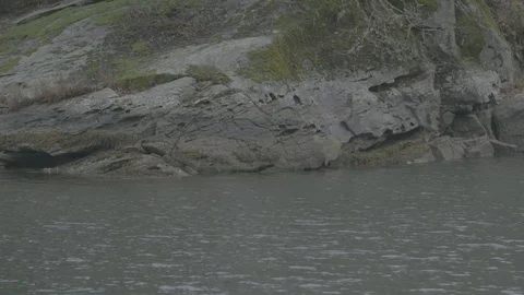 Water flows past a stone river bank Stock Footage 127120726