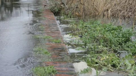 Water flows off path into river Video stock 12670235