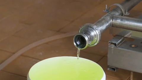 Water flows from a pipe into a white bucket. The bucket is full. Stock Footage 127885736