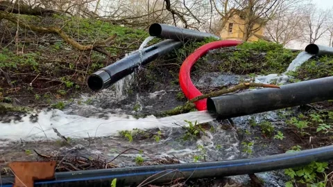 Water flows from plastic pipes into the river Stock Footage 152993902