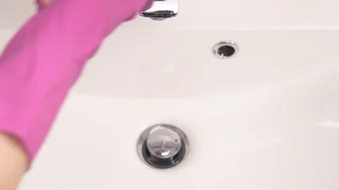 The water flows onto the purple soapy sponge. Clean house conception Stock Footage 104818790