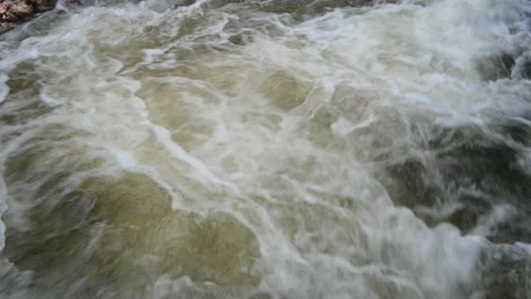 Water flows quickly in the pool of a waterfall in the mountains 스톡 동영상 219382618