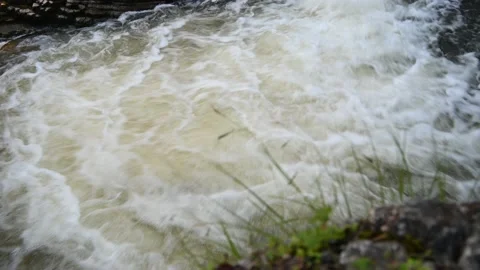 Water flows quickly in the pool of a waterfall in the mountains Stock-Footage 219382775