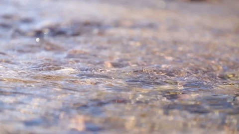 Water flows quickly in the river near the shore.	 Stock Footage 127528562