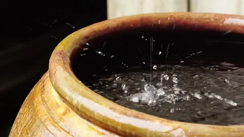 Water flows from the rain gutter into the jar. 스톡 동영상 169209435