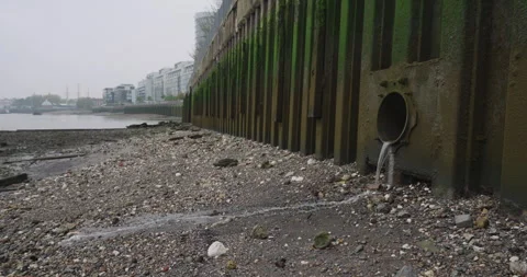 Water Flows into the River Thames from a Drainage Pipe on a Foggy Day Stock Footage 291139020