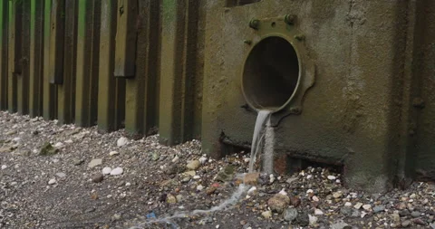 Water Flows into the River Thames from a Drainage Pipe Stock Footage 291139051