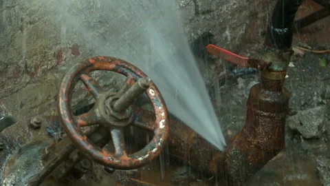 Water flows from a rusty water pipe. Water accident Stock Footage 134821513