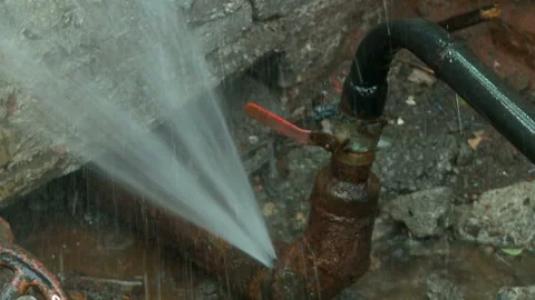 Water flows from a rusty water pipe. Water accident Stock Footage 134823964