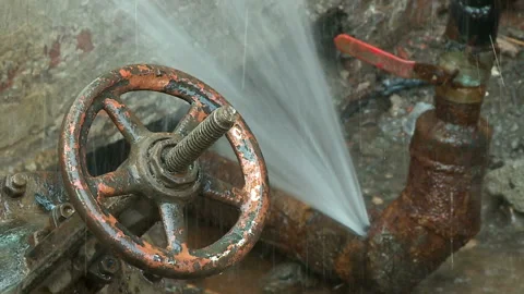 Water flows from a rusty water pipe. Water accident Stock Footage 134828406