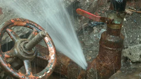 Water flows from a rusty water pipe. Water accident Stock Footage 134933545