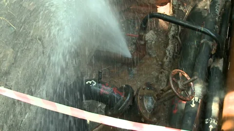 Water flows from a rusty water pipe. Water accident Stock Footage 134935514