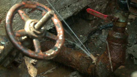 Water flows from a rusty water pipe. Water accident Stock Footage 134937211