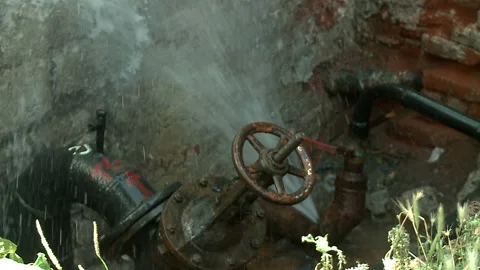Water flows from a rusty water pipe. Water accident Stock Footage 136653530