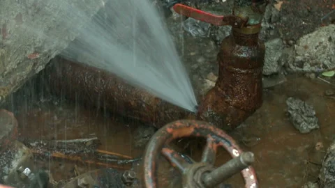 Water flows from a rusty water pipe. Water accident Stock Footage 136654098