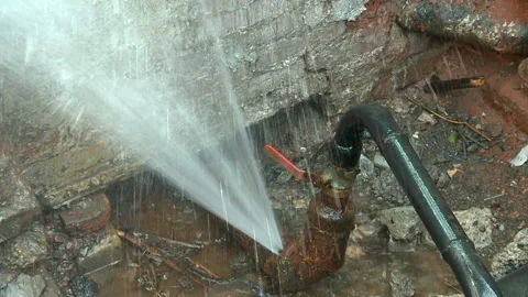 Water flows from a rusty water pipe. Water accident Stock Footage 136654701